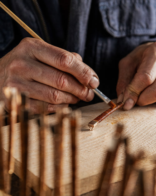 A person with a hearing aid interacts with a smartphone.