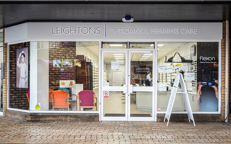 Leightons Opticians & Hearing Care store front with colorful chairs inside.