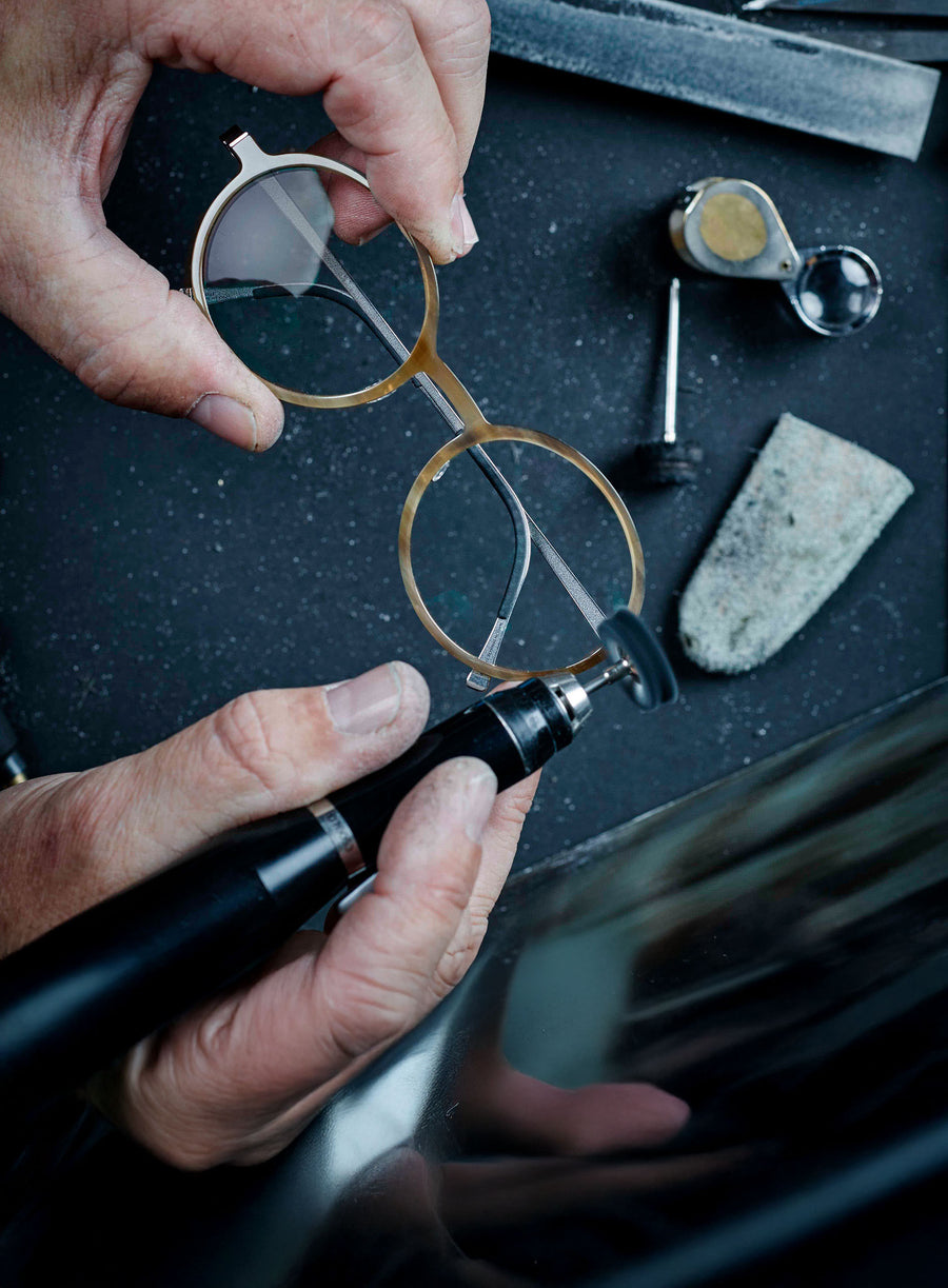 A person holding a bouquet of colorful flowers in a vibrant setting.