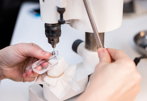 Two pairs of stylish glasses against a pink gradient backdrop.