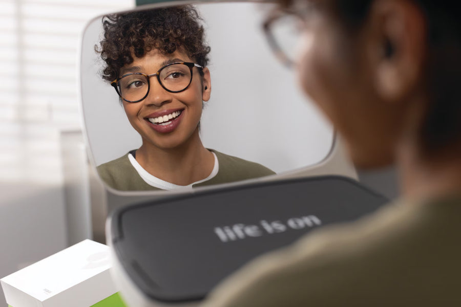 A family in matching outfits decorates a Christmas tree together.