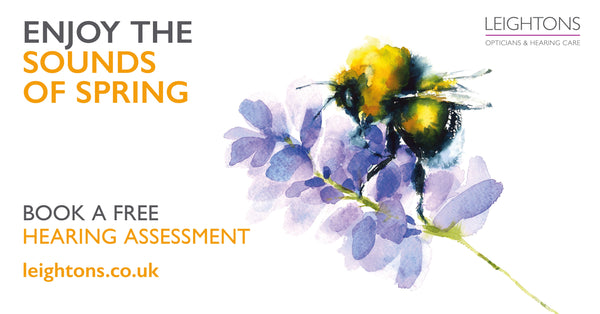 Watercolor illustration of a bee on purple flowers with text promoting free hearing assessments at Leightons opticians and hearing care.