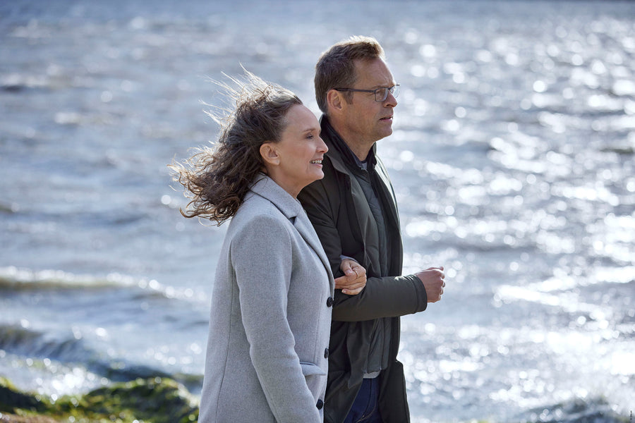 A person with glasses and a cap poses for the camera.