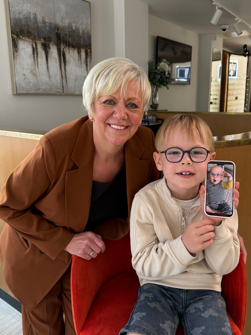 Four stylish sunglasses displayed on a colorful fabric backdrop.