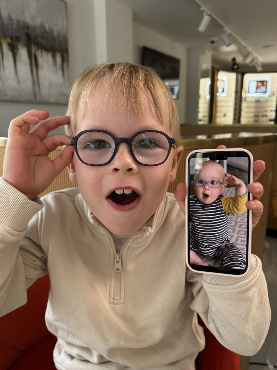 A pair of stylish sunglasses resting on a green tray.
