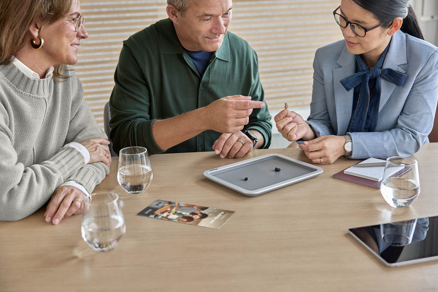 A woman experiencing a headache while sitting indoors.