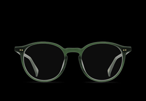 A smartwatch, sunglasses, earbuds case, and a cap on a wooden table.