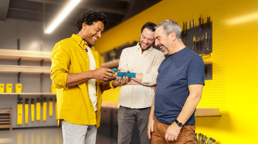 A woman wearing blue headphones listens in an audio testing room.
