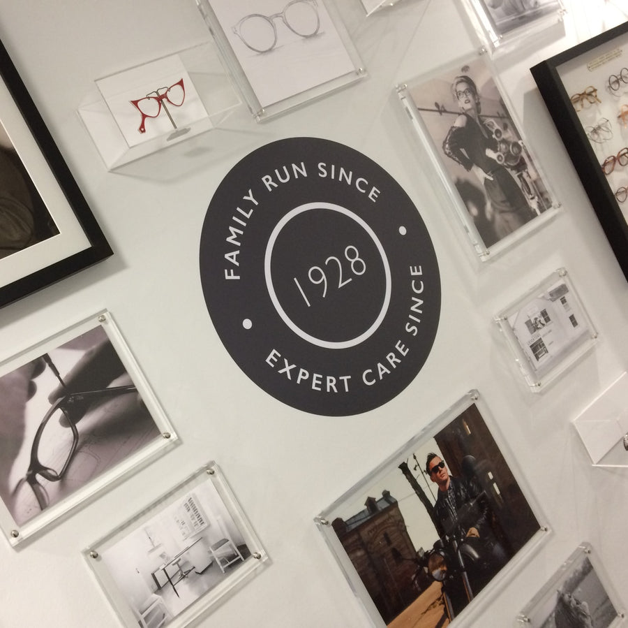 A person fires a shotgun, releasing smoke into the air.