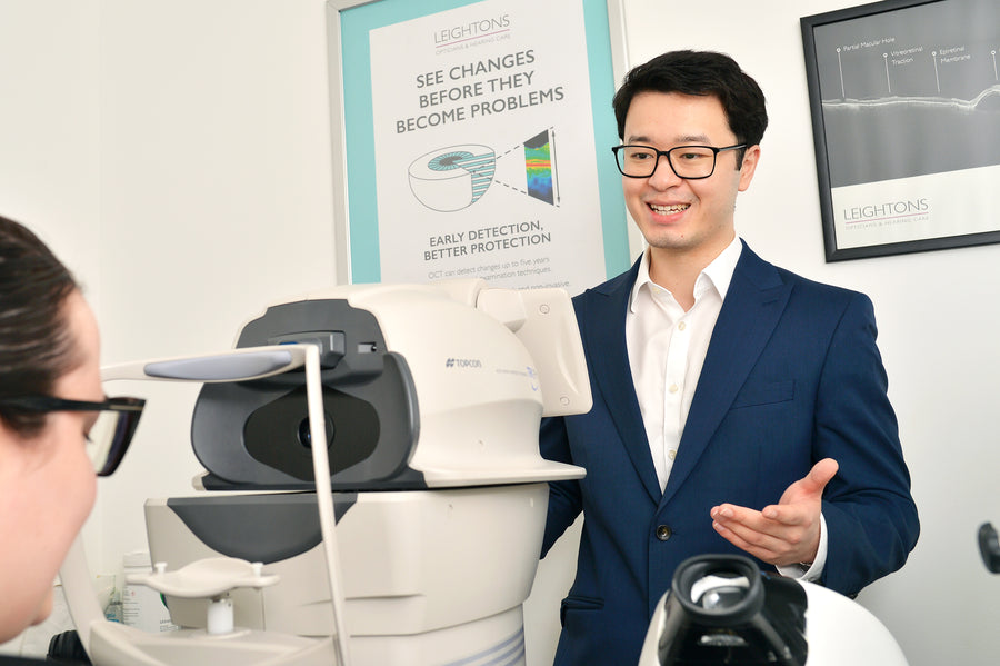 A pair of Ray-Ban glasses floating against a red background.
