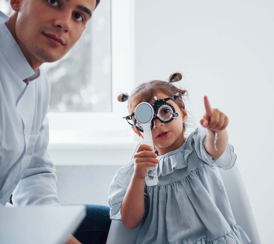 Profile view of a model wearing stylish sunglasses against a blue background.