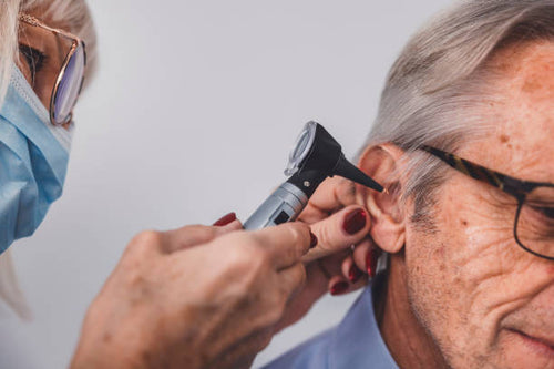A smiling businessman in a suit with a tie against a white background.