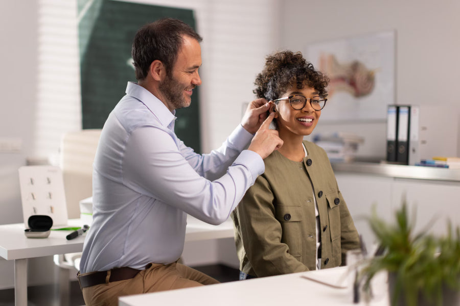 A young man enjoys a bowl of noodles using chopsticks.