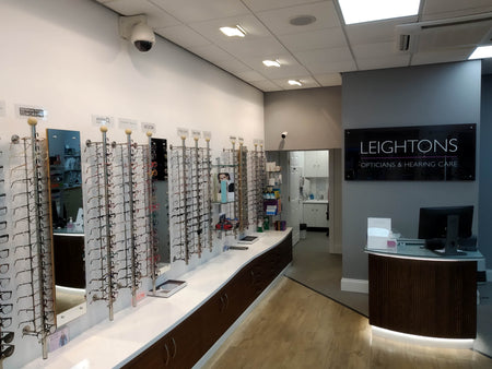 Optician's office with eyeglass frames on display and 'Leightons' branding.