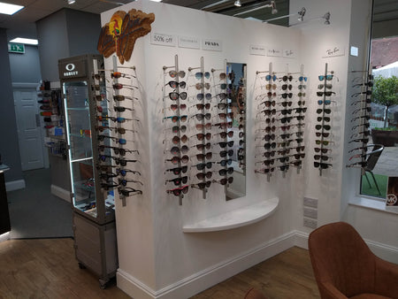 Display of sunglasses on a wall in a store