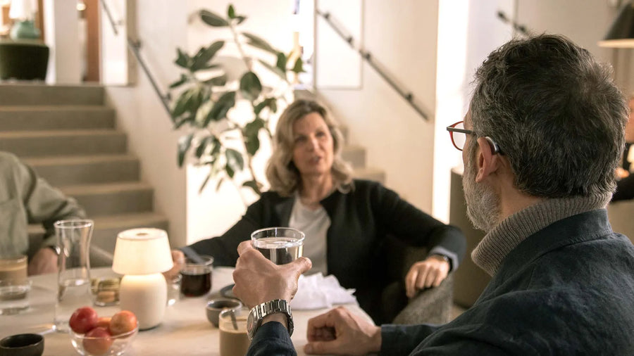 Three men enjoying a moment in a workshop, smiling together.