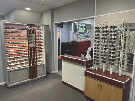 Optometry office interior with shelves of eyeglasses.