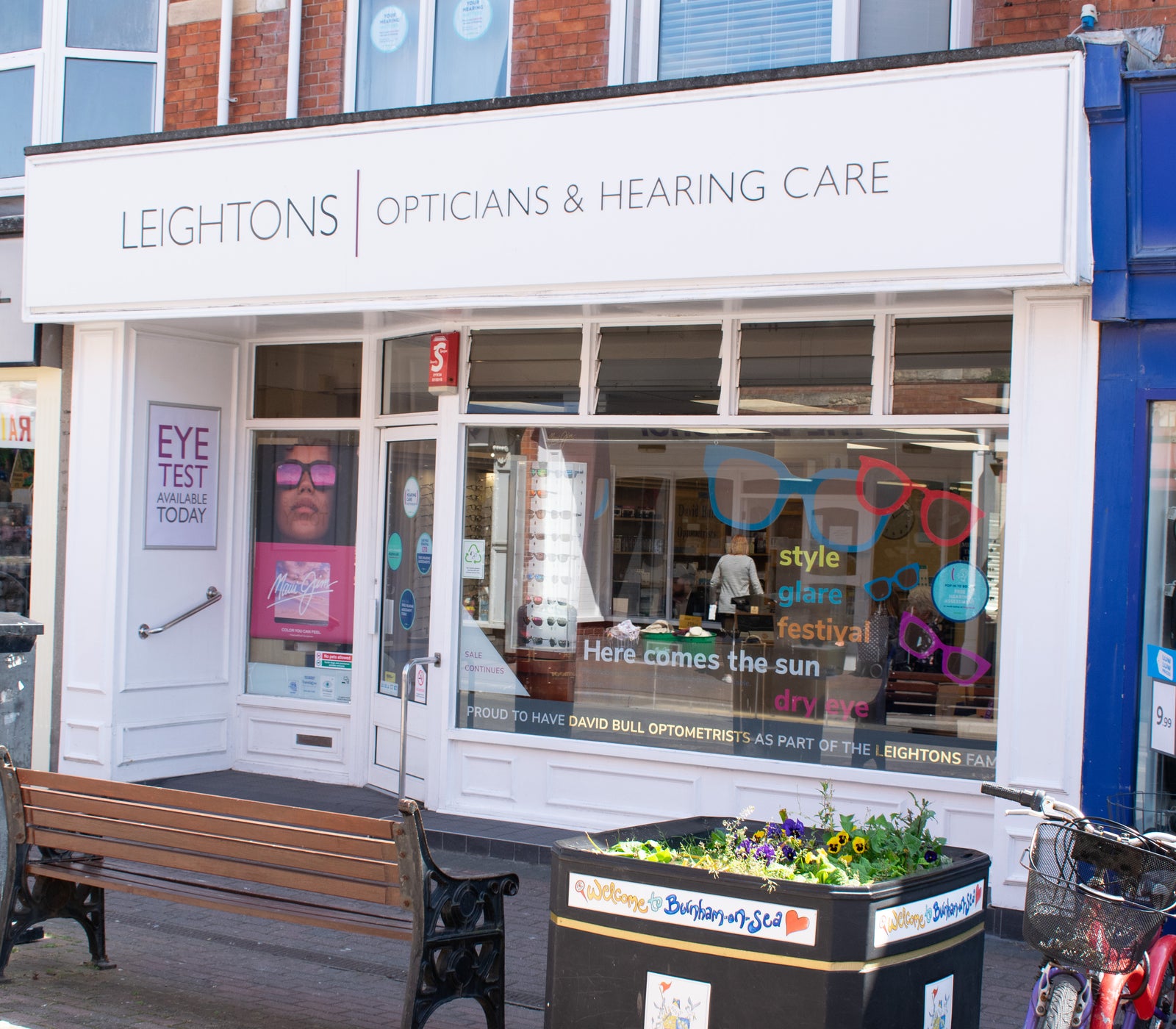 Stylish white sunglasses featuring orange and yellow lenses.