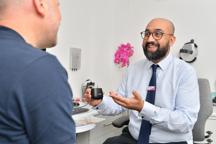 A sleek white electronic eyelash curler with buttons.