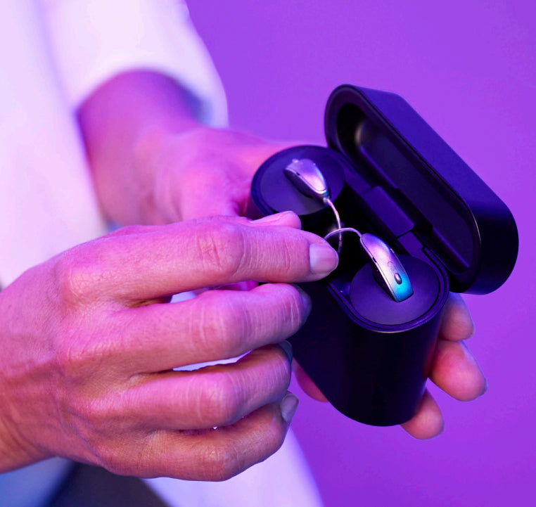 A young man wearing stylish Tom Ford sunglasses with a denim shirt.