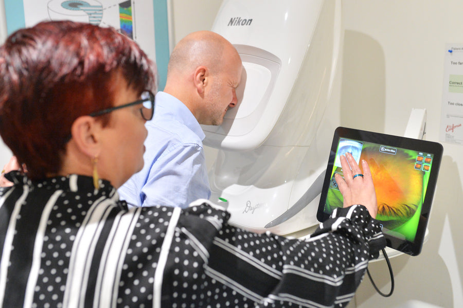 Stylish oversized sunglasses with a deep red frame and purple lenses.