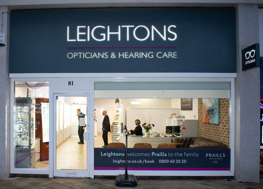 A pair of stylish white sunglasses with yellow lenses.